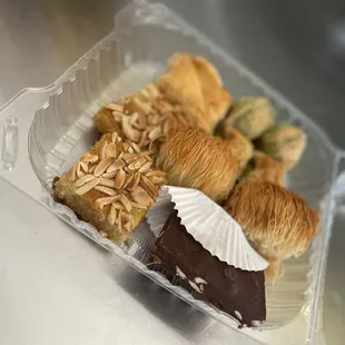 a variety of pastries in a plastic container