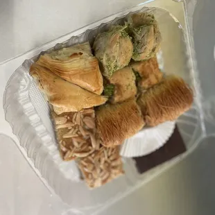 a variety of pastries in a plastic container