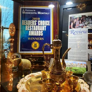 a gold teapot on a plate