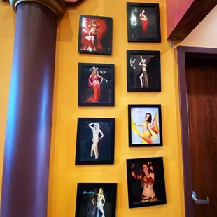 a wall of framed photos