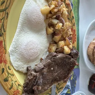 Steak and perfectly cooked over easy eggs. It was a real strip steak folks.