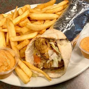 Chicken Pita with French Fries and Spicy Sauce.