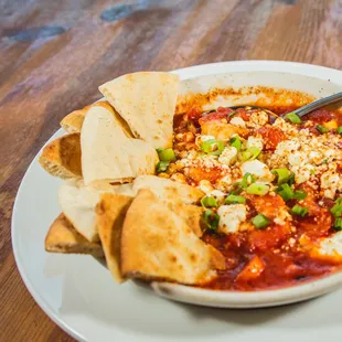 a bowl of pizzeria with pita chips