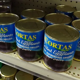 cans of olives and pickles on a shelf