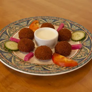 a plate of appetizers on a wooden table