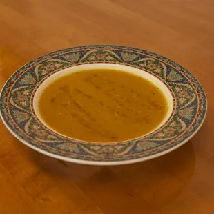a bowl of soup on a wooden table
