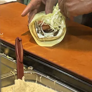 a person making a tortilla