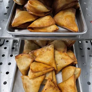 Samosas with different types of fillings such as beef, veggie, and spinach/ cheese.