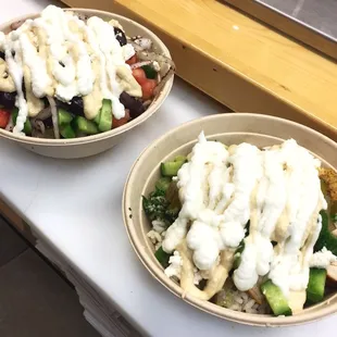 two bowls of salad with dressing