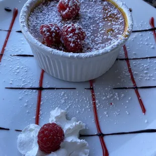 a dessert with raspberries and whipped cream