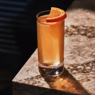 a glass of orange juice on a table