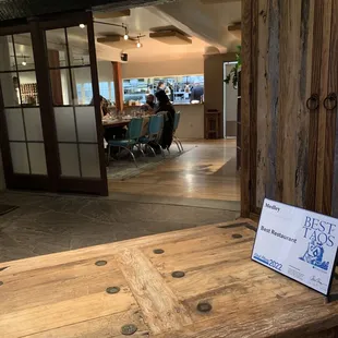 a wooden table with a sign on it