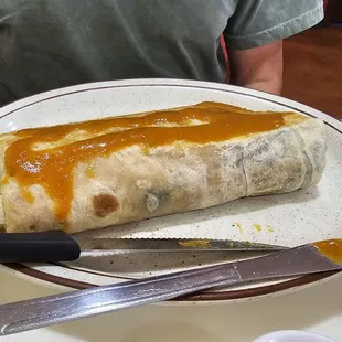 Chile relleno burrito with added rice and beans (inside) and medium sauce
