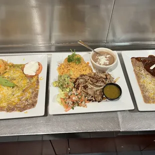 three plates of food on a counter