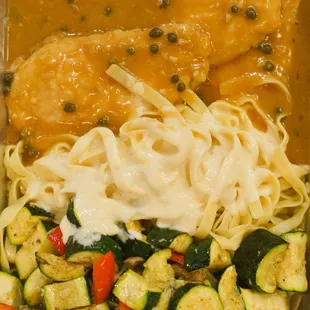 a plate of pasta, vegetables, and chicken