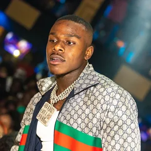 a man in a gucci shirt and tie