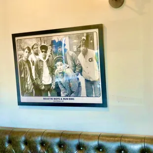 tufted seating inside and old school rappers wall poster