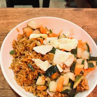 Nasi Goreng with sunny side up egg. Mix it with all the other veggies to enjoy the wonderful flavor. Requested not spicy at all.