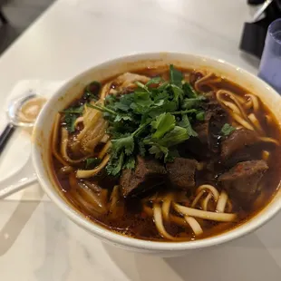 a bowl of beef and noodles