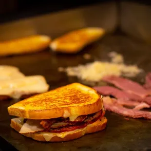 a grilled sandwich with meat and cheese