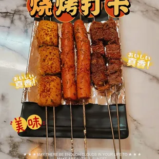 a variety of meats on skewers