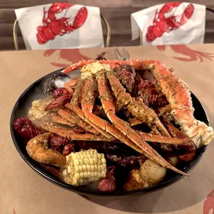 a plate of crab legs and corn on the cob