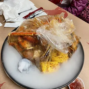 Seafood combo - snow crab, sausage, shrimps, clams, corn cob in garlic butter sauce.