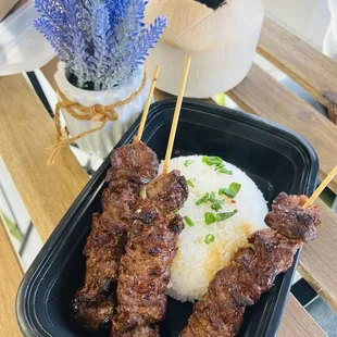 Beef stick with jasmine rice. Along with a fresh coconut drink.