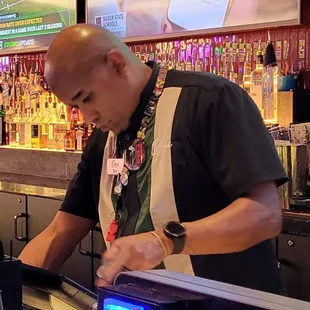 a man preparing a drink at a bar