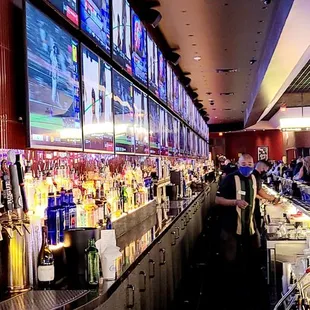 people watching televisions at a sports bar