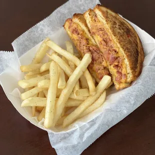 a grilled sandwich and french fries