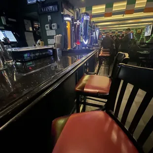 a bar with red leather chairs