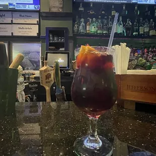 a drink in a glass on a bar