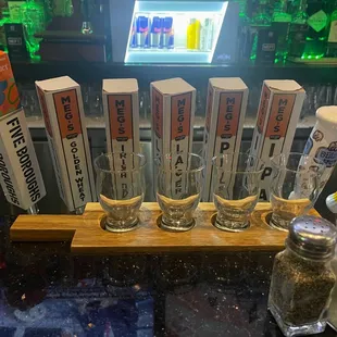 a row of beer glasses on a bar