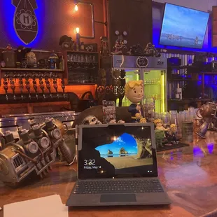 a laptop on a bar counter