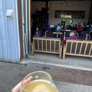 a person holding a glass of beer