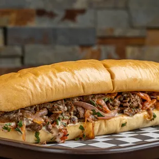 The Beef Pitcher:
Marinated thin sliced beef with special spices, tahini dressing, onions, tomatoes and parsley.