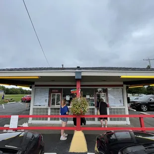 a woman standing in front of a restaurant