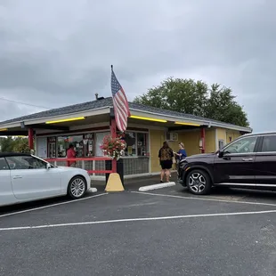 two cars parked in front of the store