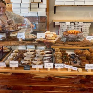 a woman behind a bakery counter