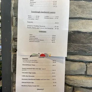 a menu on a brick wall