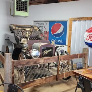 an old car in the center of the room