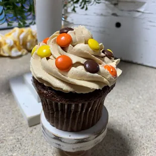 a chocolate cupcake with frosting and candy