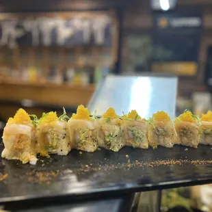 a closeup of a sushi on a black plate