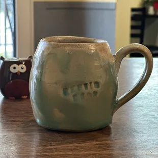 Cup of coffee in the cutest mug with a salt and pepper owl to watch over my meal