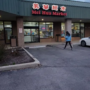 a woman walking in front of the store