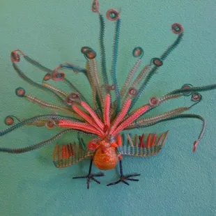 Cool peacock decoration made out of some kind of colored wire