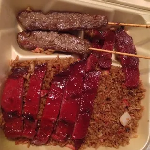 Combo #16 of BBQ pork, beef on a stick over pork fried rice.