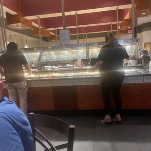 two people standing at the counter