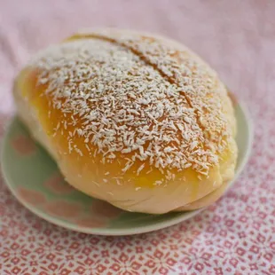 Soft roll with cream inside + coconut flakes